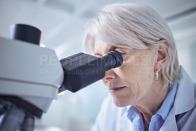 Buy stock photo Shot of a mature scientist using a microscope in her lab