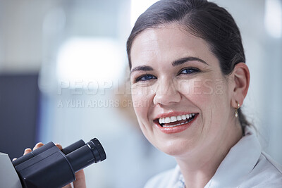 Buy stock photo Shot of a young female lab tech using her microscope