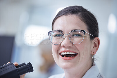 Buy stock photo Shot of a young female lab tech using her microscope