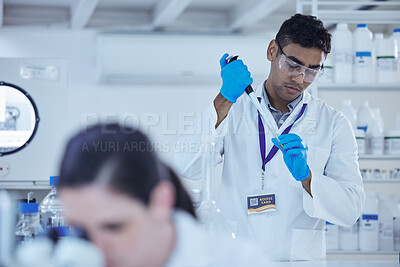 Buy stock photo Shot of a male scientist decanting samples into test tubes