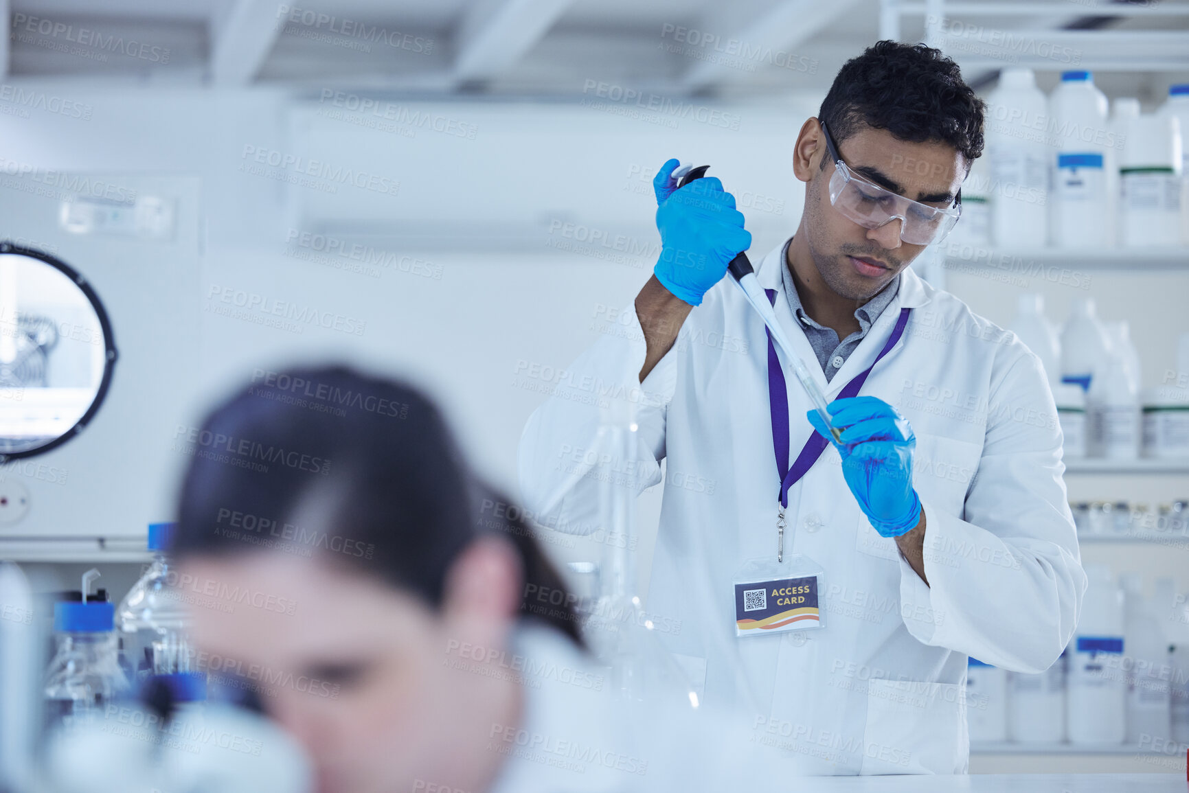 Buy stock photo Shot of a male scientist decanting samples into test tubes