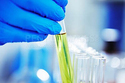 Buy stock photo Shot of an unknown scientist inserting a test tube into a tray