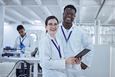 Buy stock photo Shot of two colleagues working together on a scientific project using a digital tablet
