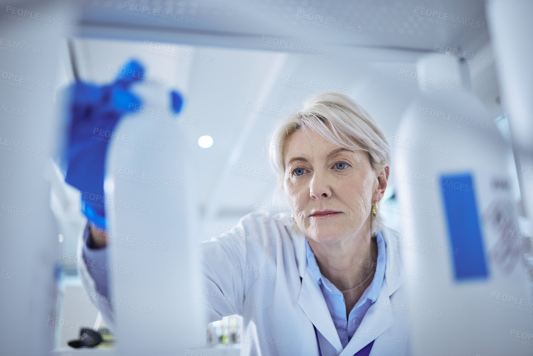 Buy stock photo Mature scientist, product and medical research in science lab for chemistry experiment in healthcare. Female person, storage and chemical for pharmaceutical test, analysis or mpox vaccine in hospital