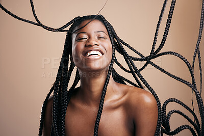 Buy stock photo Cropped shot of an attractive young woman posing in studio against a brown background