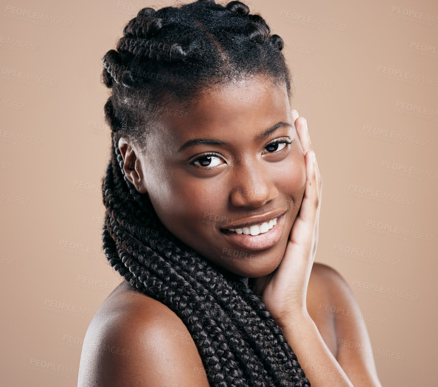 Buy stock photo Cropped portrait of an attractive young woman posing in studio against a brown background