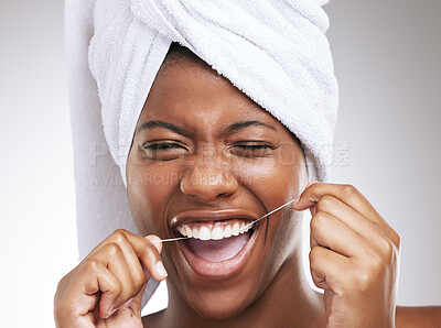 Buy stock photo Happy, black woman and portrait with dental floss for teeth cleaning, hygiene or gum care on a studio background. Young African, female person or model with smile for tooth, mouth or oral cavity