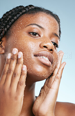 Buy stock photo Beauty, skincare and scrub with face of black woman in studio for cosmetics, exfoliate and facial. Self care, glow and shine with female model on blue background for clean, dermatology and spa