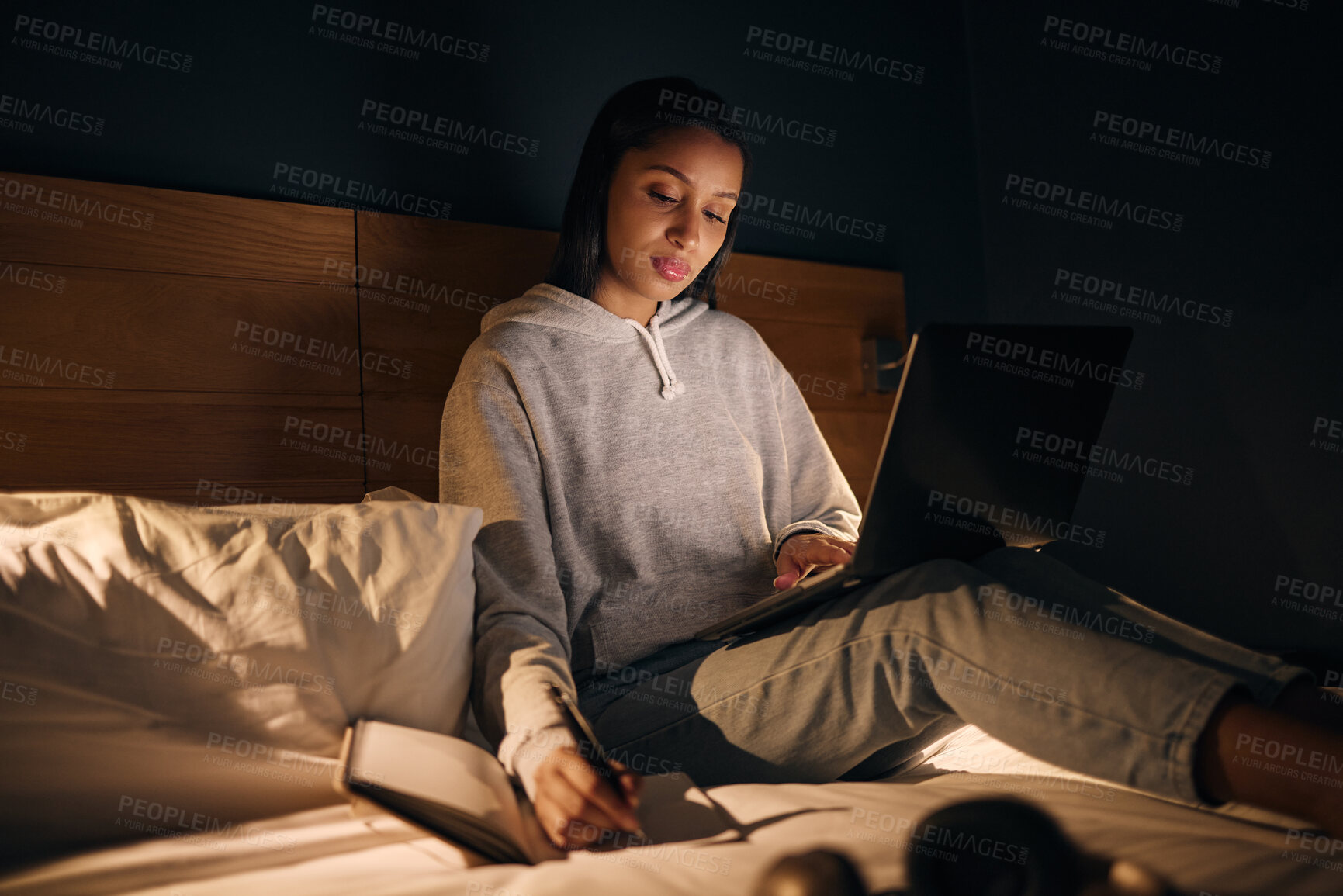 Buy stock photo Woman, laptop and notebook at night for study, learning and university in home on bed with online course. Student, technology and writing in apartment for college exam, education and research project