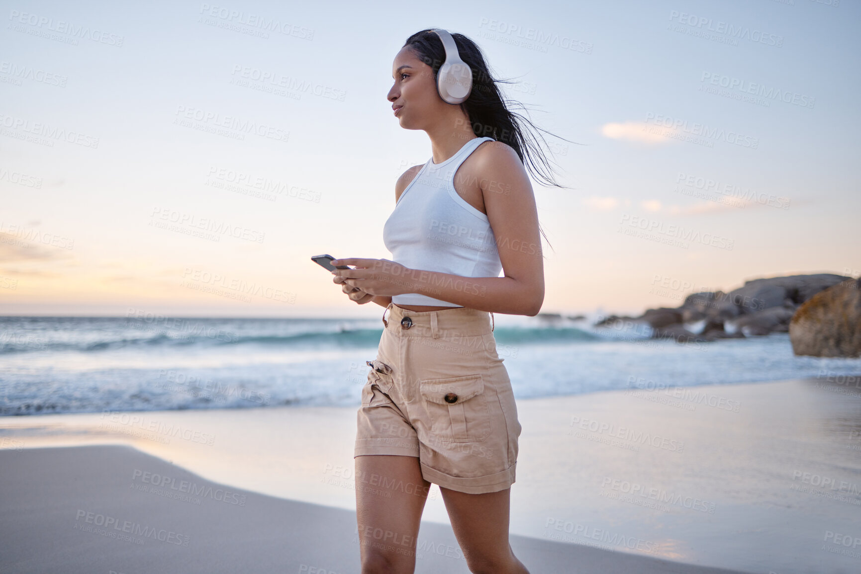 Buy stock photo Beach, woman and thinking with smartphone on headphones for music, audio and radio in Brazil. Female person, seaside and satisfied on profile with streaming for motivational sound to relax on break