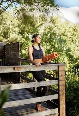 Buy stock photo Full length shot of an attractive young female athlete standing with her yoga mat outdoors