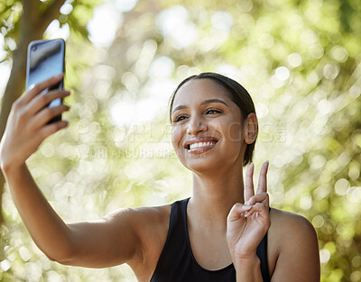 Buy stock photo Cropped shot of an attractive young female athlete taking selfies while exercising outdoors