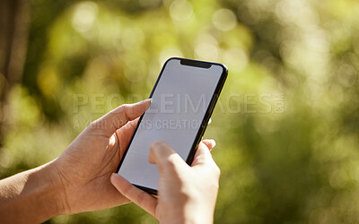 Buy stock photo Closeup shot of an unrecognizable woman using her cellphone while standing outside