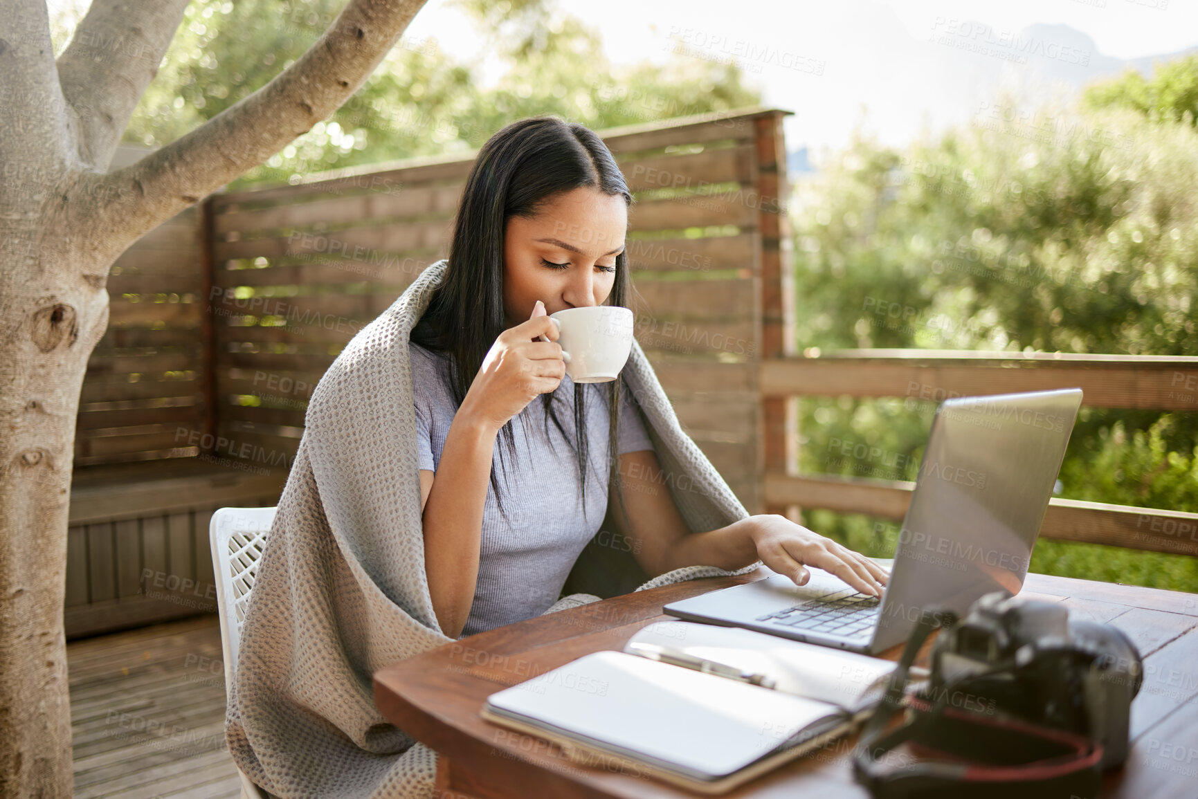 Buy stock photo Editing, drink and woman in cafe with laptop for remote work, creative notes and research planning on patio. Relax, ideas and freelance photographer at coffee shop with article for online travel blog