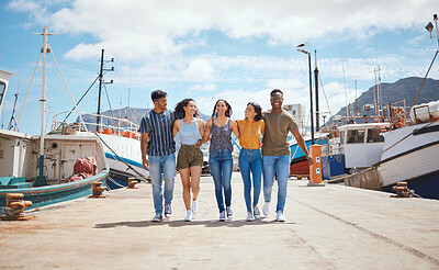 Buy stock photo Friends, happy and walking on dock for travel, journey and excited for new adventure on sea. People, laugh and boats at harbor for summer vacation, holiday reunion and support with group diversity