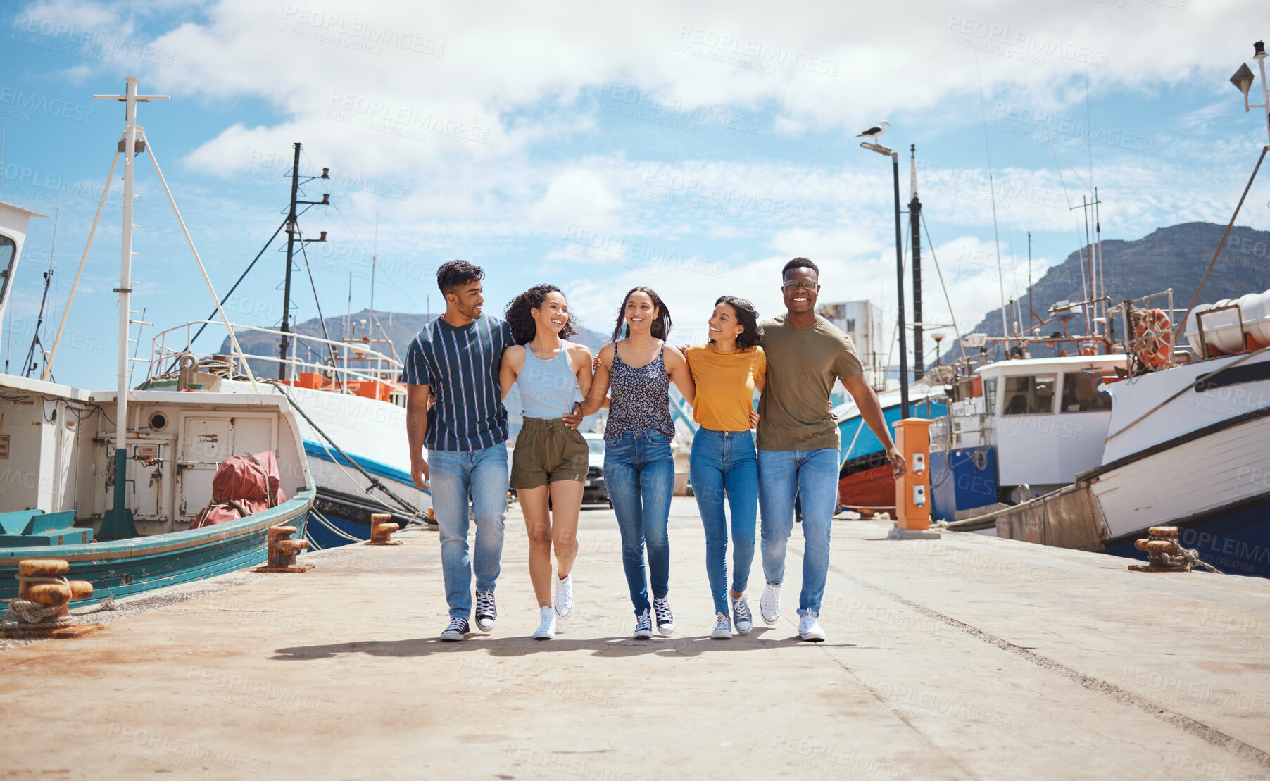 Buy stock photo Friends, happy and walking on dock for travel, journey and excited for new adventure on sea. People, laugh and boats at harbor for summer vacation, holiday reunion and support with group diversity