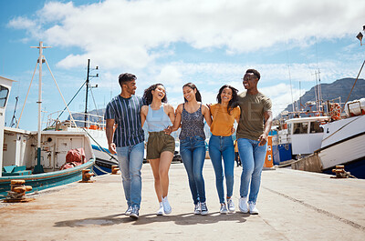 Buy stock photo Friends, happy and walking on harbor for travel, journey and excited for new adventure on sea. People, laugh and boats at dock for summer vacation, holiday reunion and support with group diversity