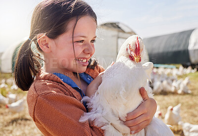Buy stock photo Shot of an adorable little girl holding a chicken on a farm