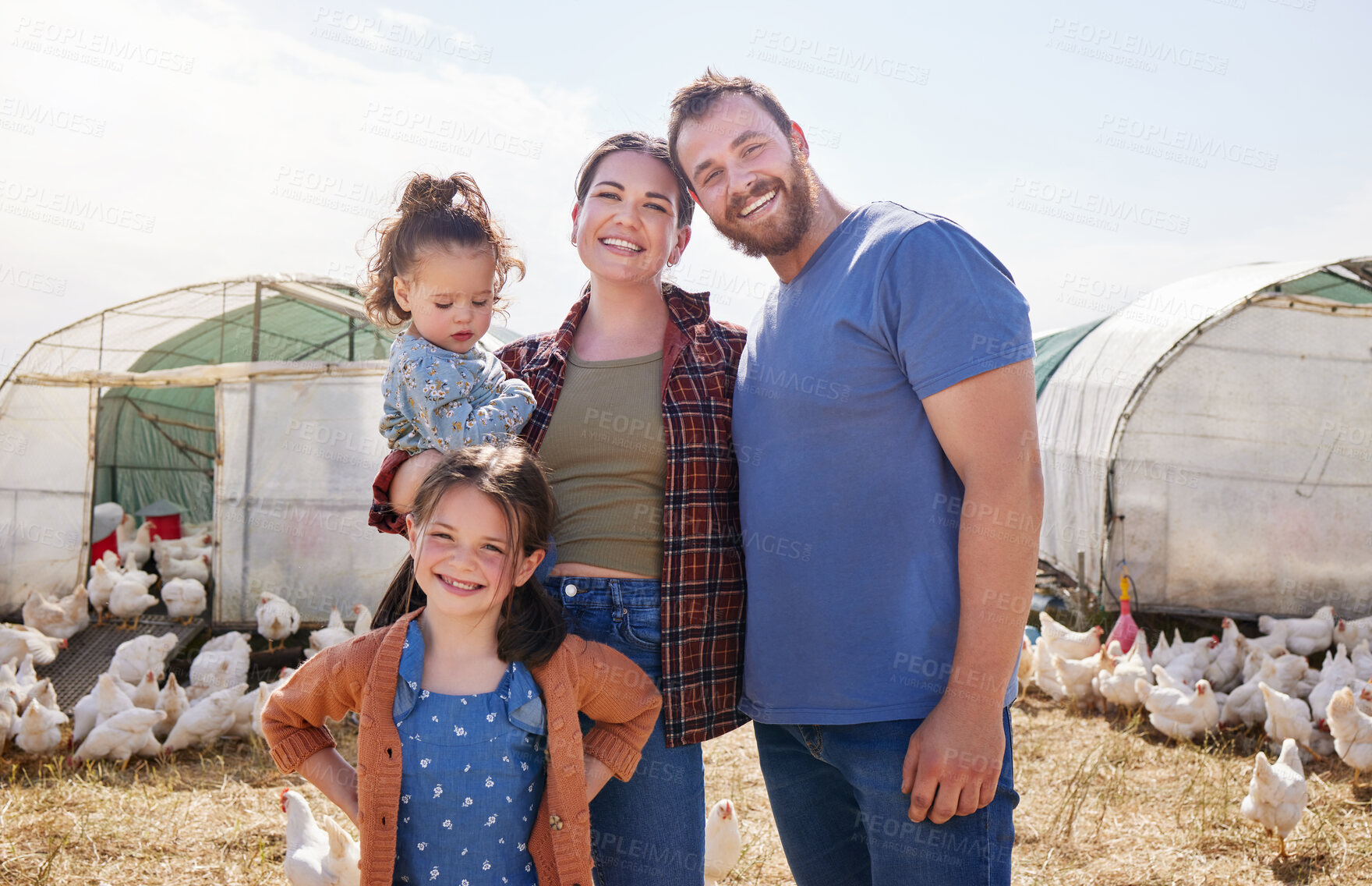 Buy stock photo Shot of a couple and their two daughters on a poultry farm