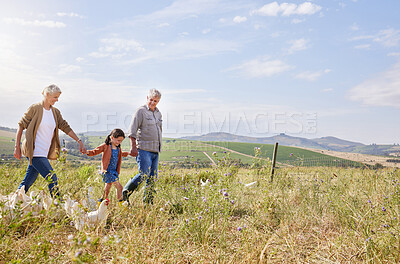 Buy stock photo Shot of a mature couple and their granddaughter on a poultry farm