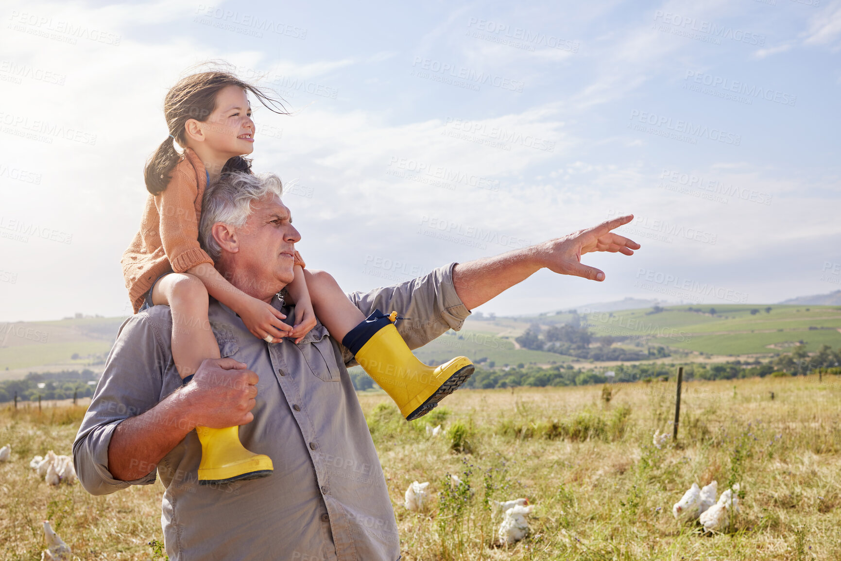 Buy stock photo Shot of a mature man bonding with his granddaughter on a poultry farm