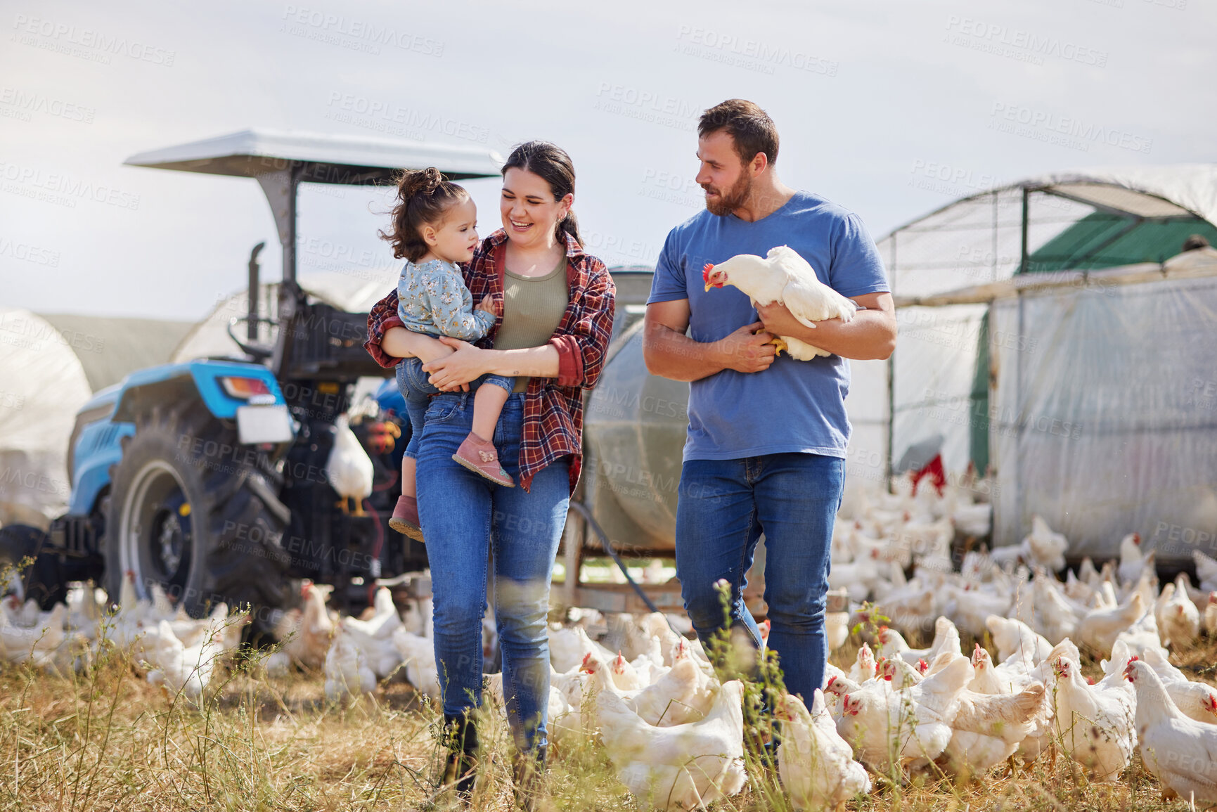 Buy stock photo Shot of a couple and their adorable daughter on a poultry farm