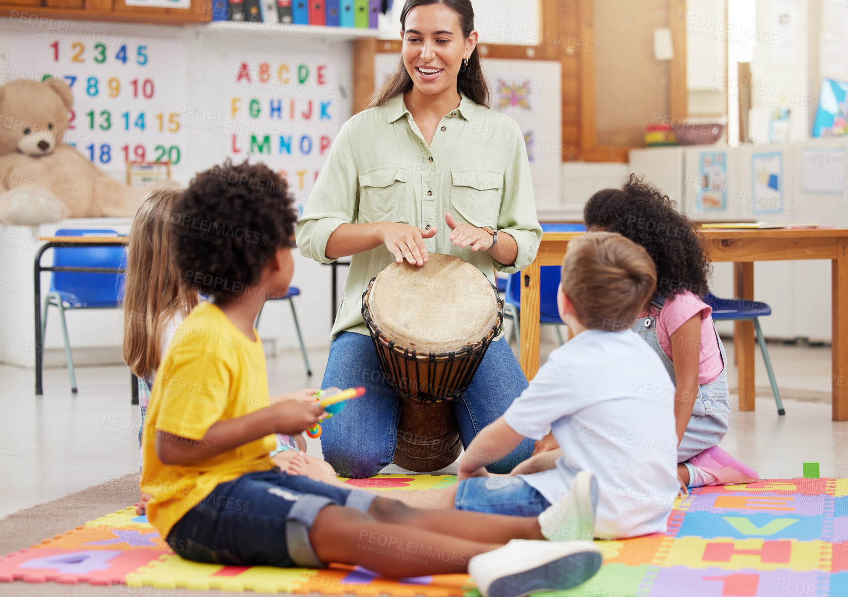 Buy stock photo Shot of a woman teaching her class about musical instruments