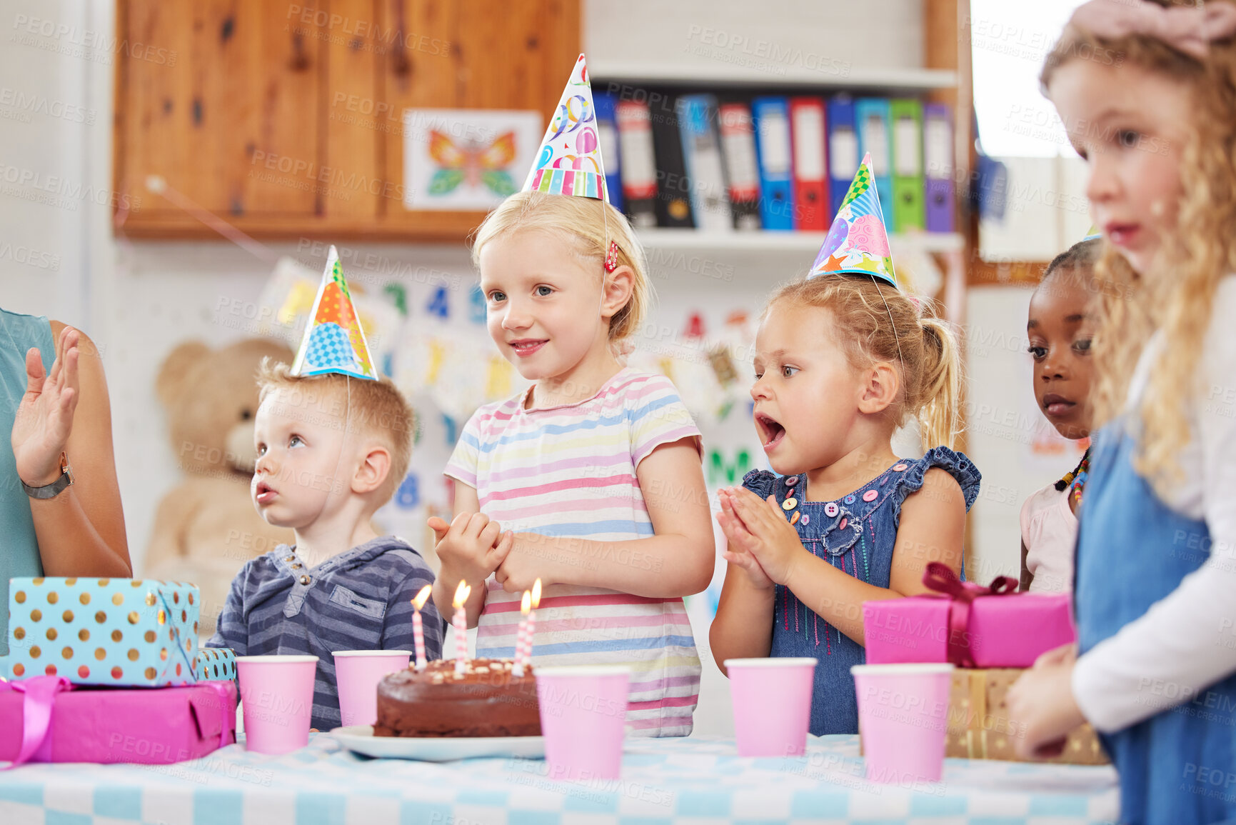 Buy stock photo Shot of a preschool children celebrating a birthday in class