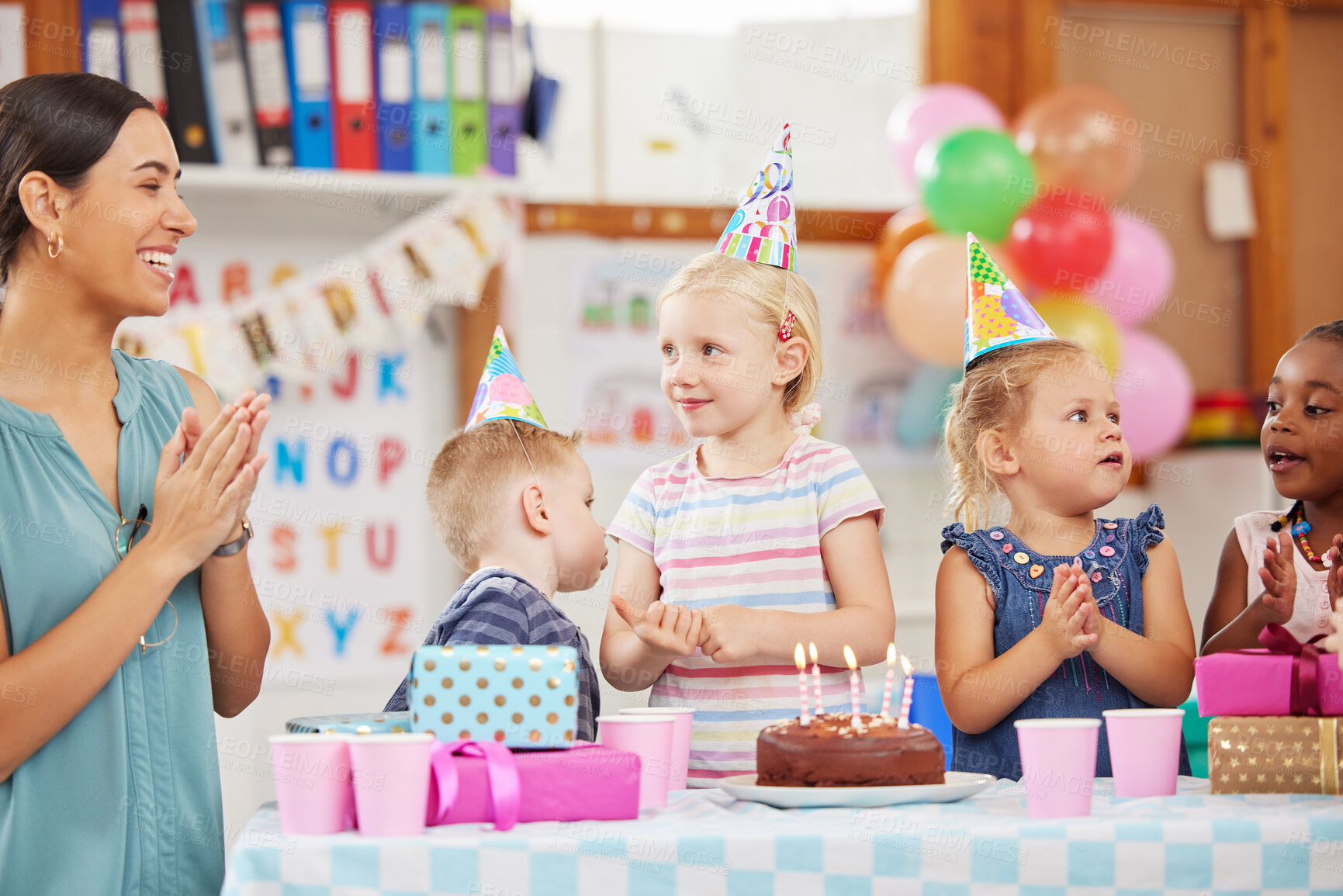 Buy stock photo Teacher, children and birthday for celebration in classroom, happy or excited with cake for party. Kids, smile and diversity with woman for support, snack or dessert at kindergarten, creche or school