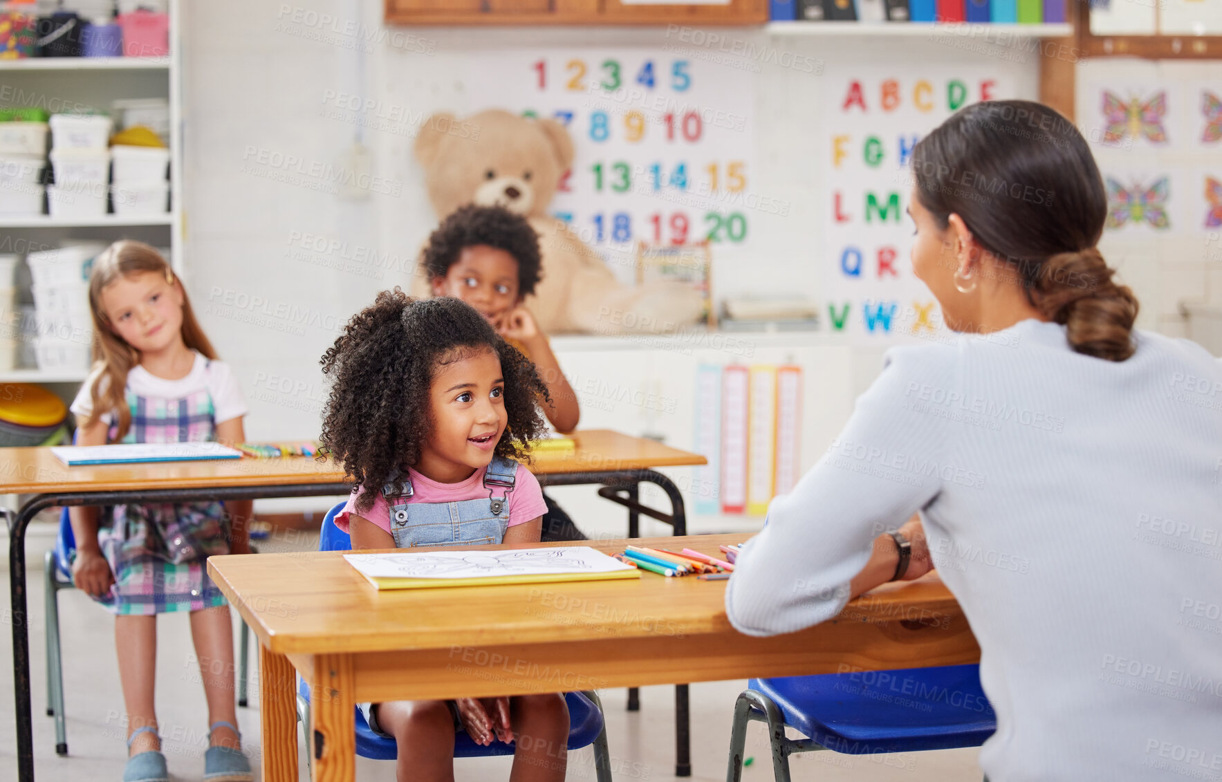 Buy stock photo Shot of a young woman teaching a class of preschool children