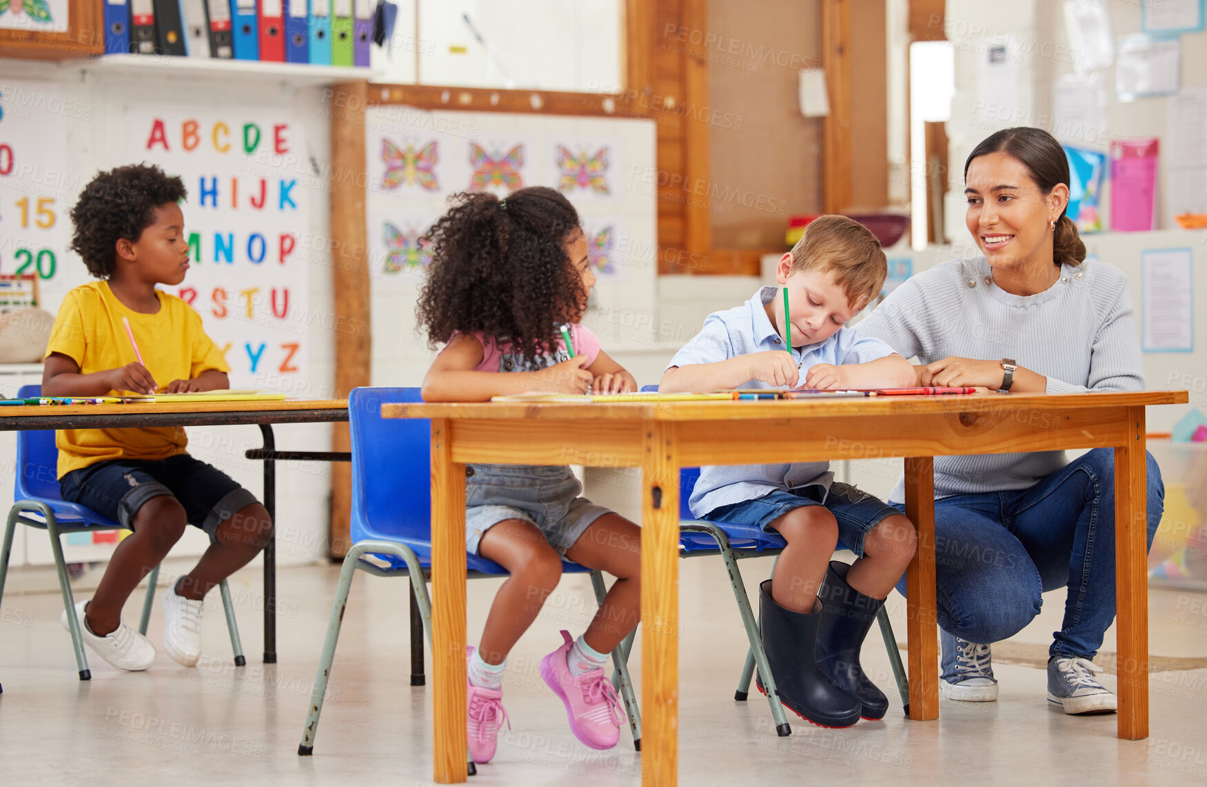 Buy stock photo Shot of a young woman teaching a class of preschool children