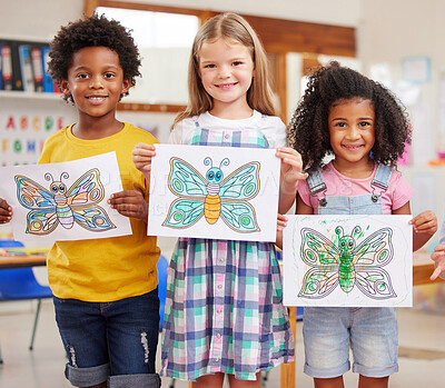 Buy stock photo Shot of a three preschool students showing off their artwork in class