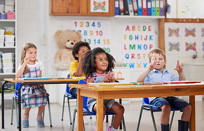 Buy stock photo Shot of a group of preschool students sitting in a classroom