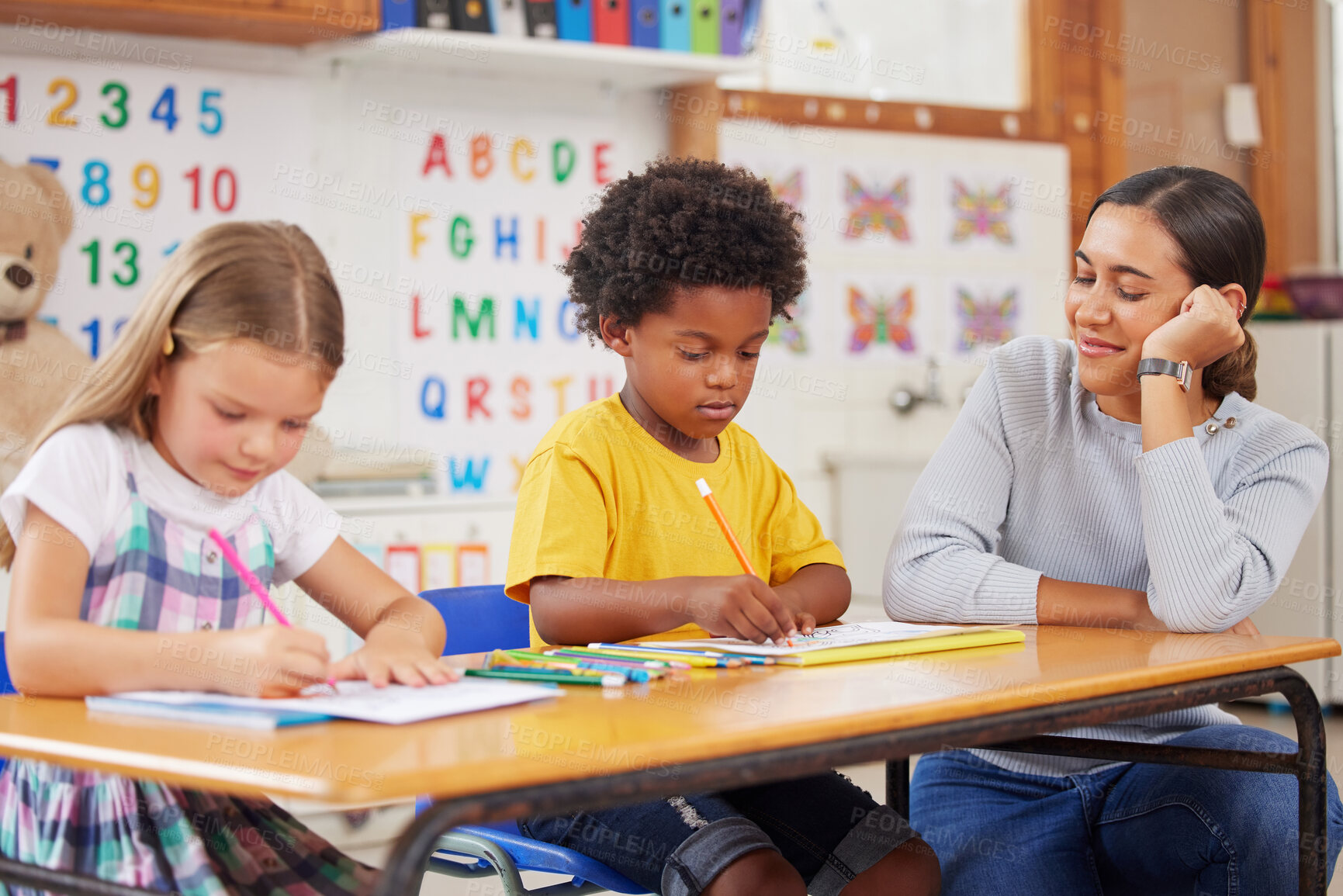 Buy stock photo Shot of a young woman teaching a class of preschool children