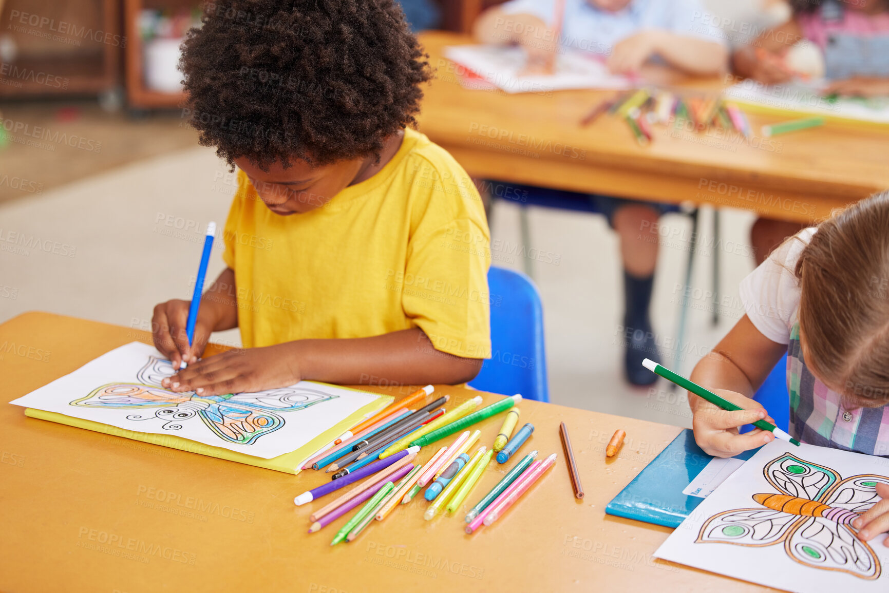 Buy stock photo Shot of preschool students colouring in class