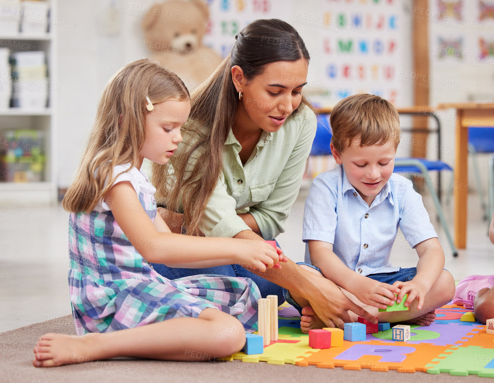 Buy stock photo Education, teacher and woman with children, building blocks and construction toys for motor skills in class. Knowledge, teaching and students with shapes for spatial awareness, growth and development