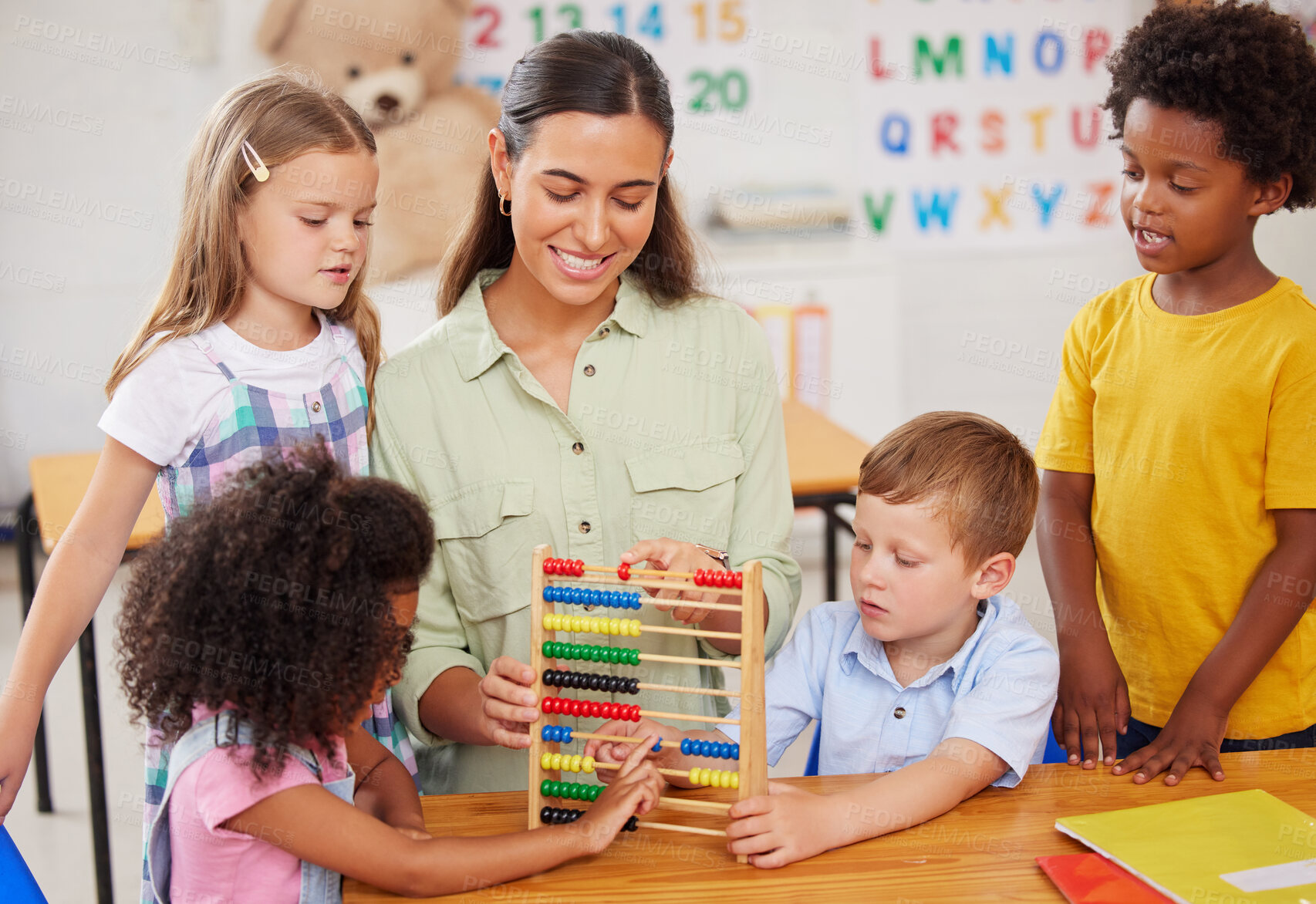 Buy stock photo Shot of a young woman teaching a class of preschool children