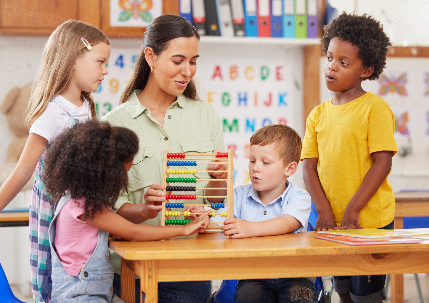 Buy stock photo Shot of a young woman teaching a class of preschool children