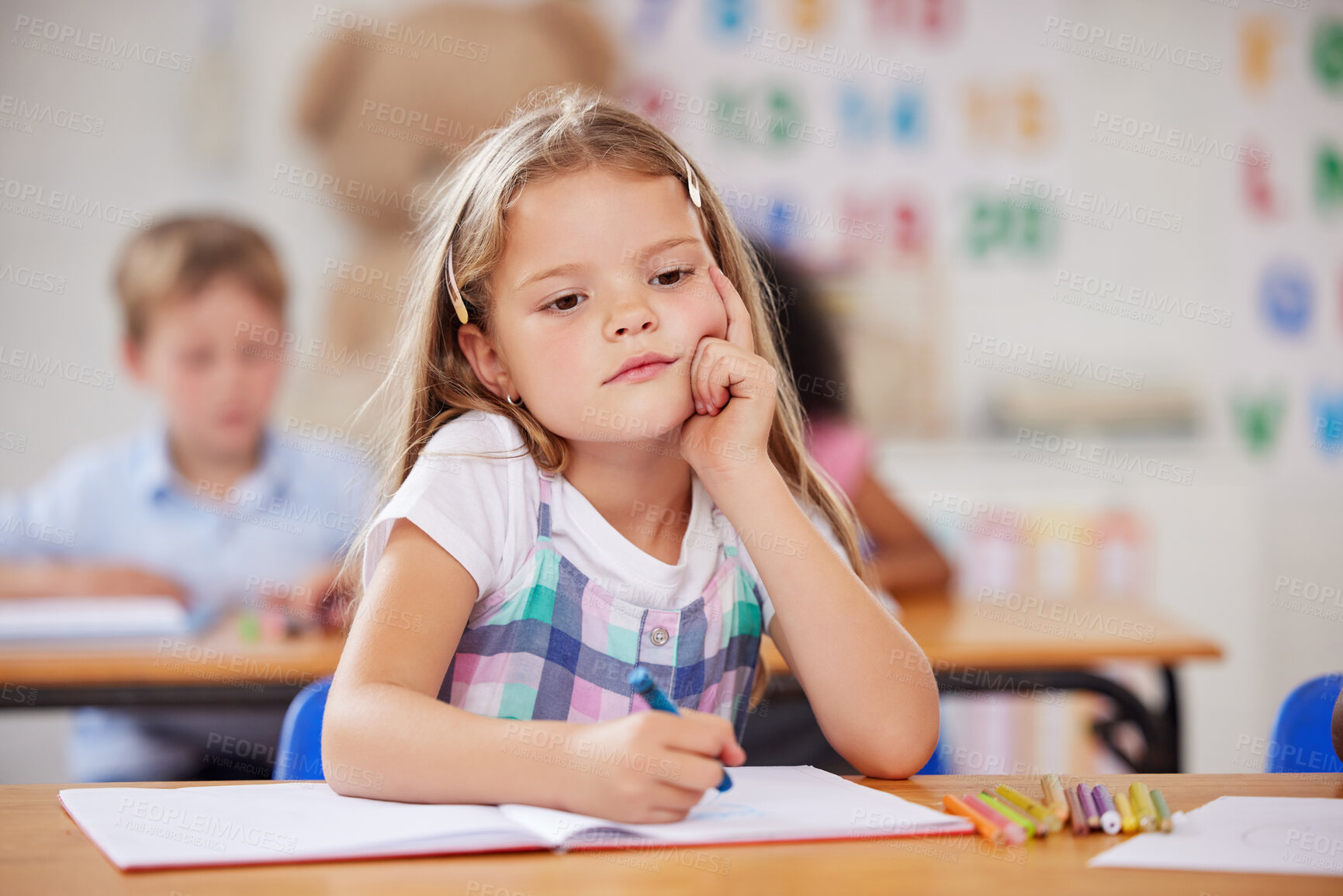 Buy stock photo Shot of a preschool student looking thoughtful while sitting in class