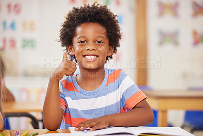 Buy stock photo Shot of a preschool student showing thumbs up while sitting in class