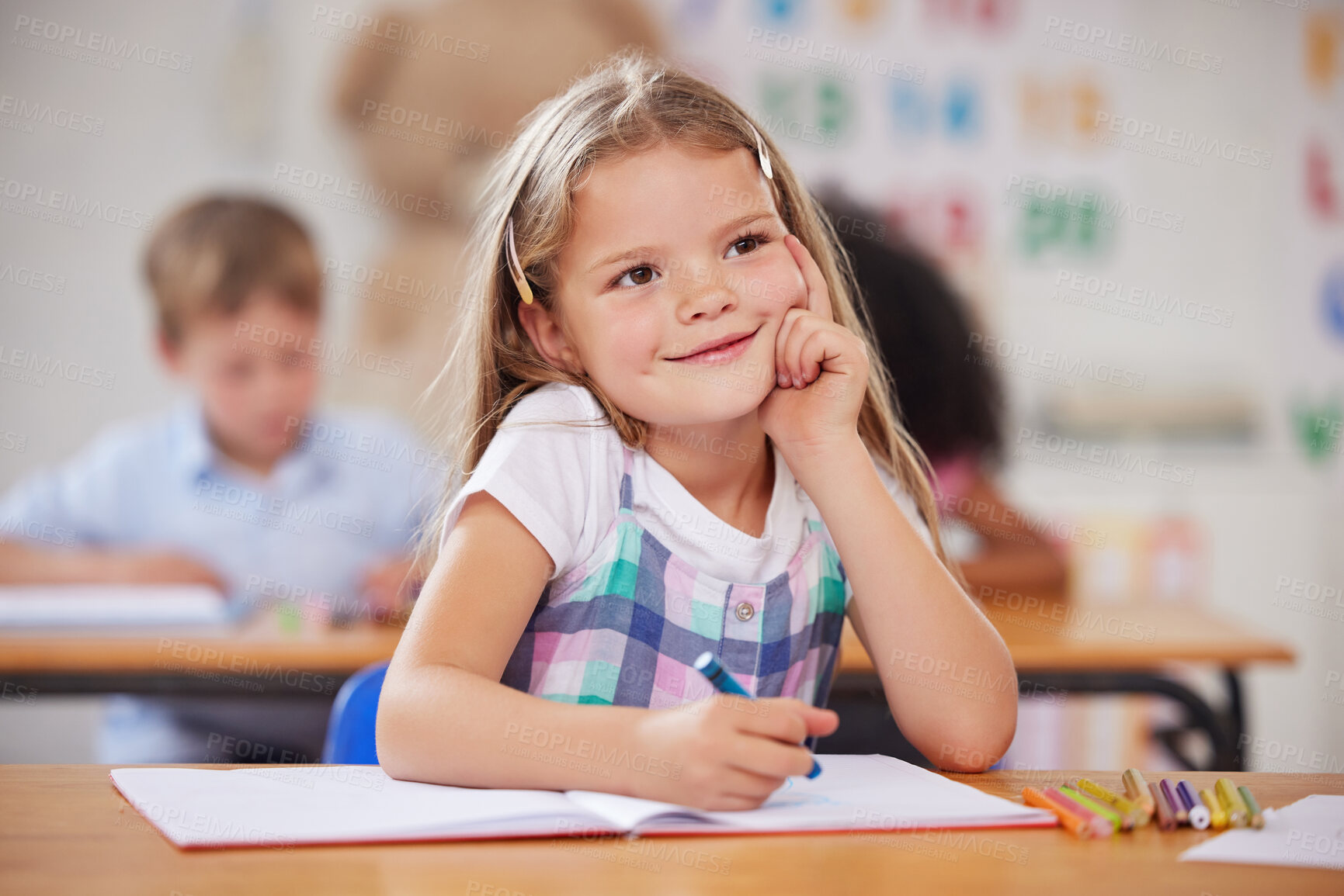 Buy stock photo Shot of a preschool student looking thoughtful while sitting in class