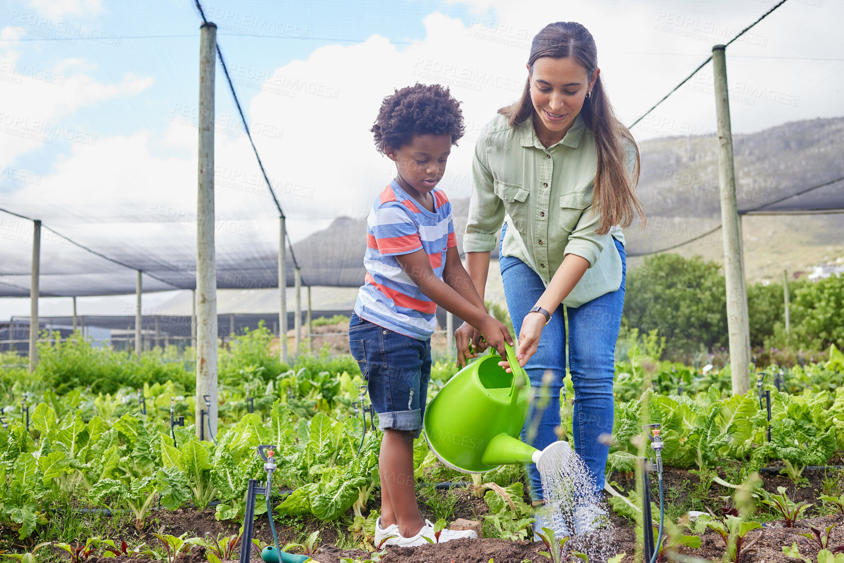 Buy stock photo Full length shot of an attractive young woman and adorable little boy working on a farm