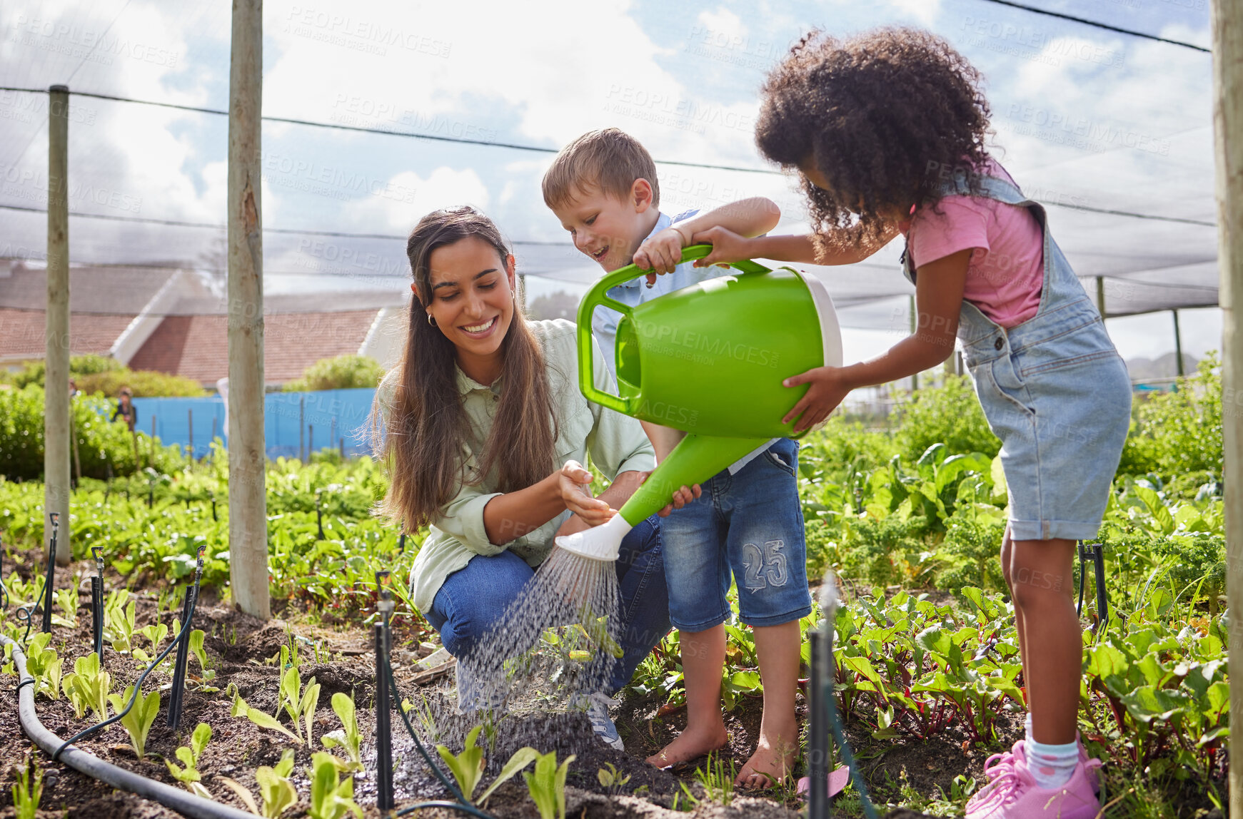 Buy stock photo Full length shot of an attractive young woman and two adorable little kids working on a farm