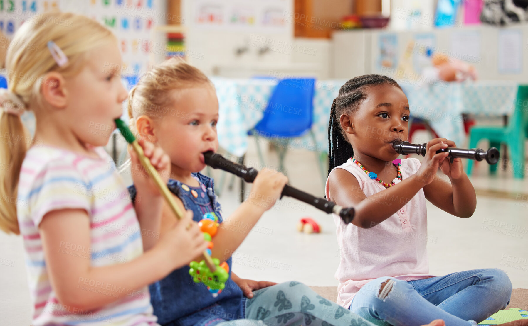 Buy stock photo Shot of children learning about musical instruments in class