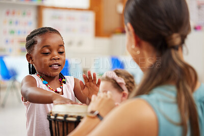 Buy stock photo Shot of a woman teaching a child about musical instruments in class