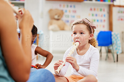Buy stock photo Shot of a woman teaching her students about musical instruments in class