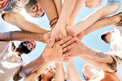 Buy stock photo Low angle shot of an unrecognisable group of friends standing together and stacking their hands in the middle