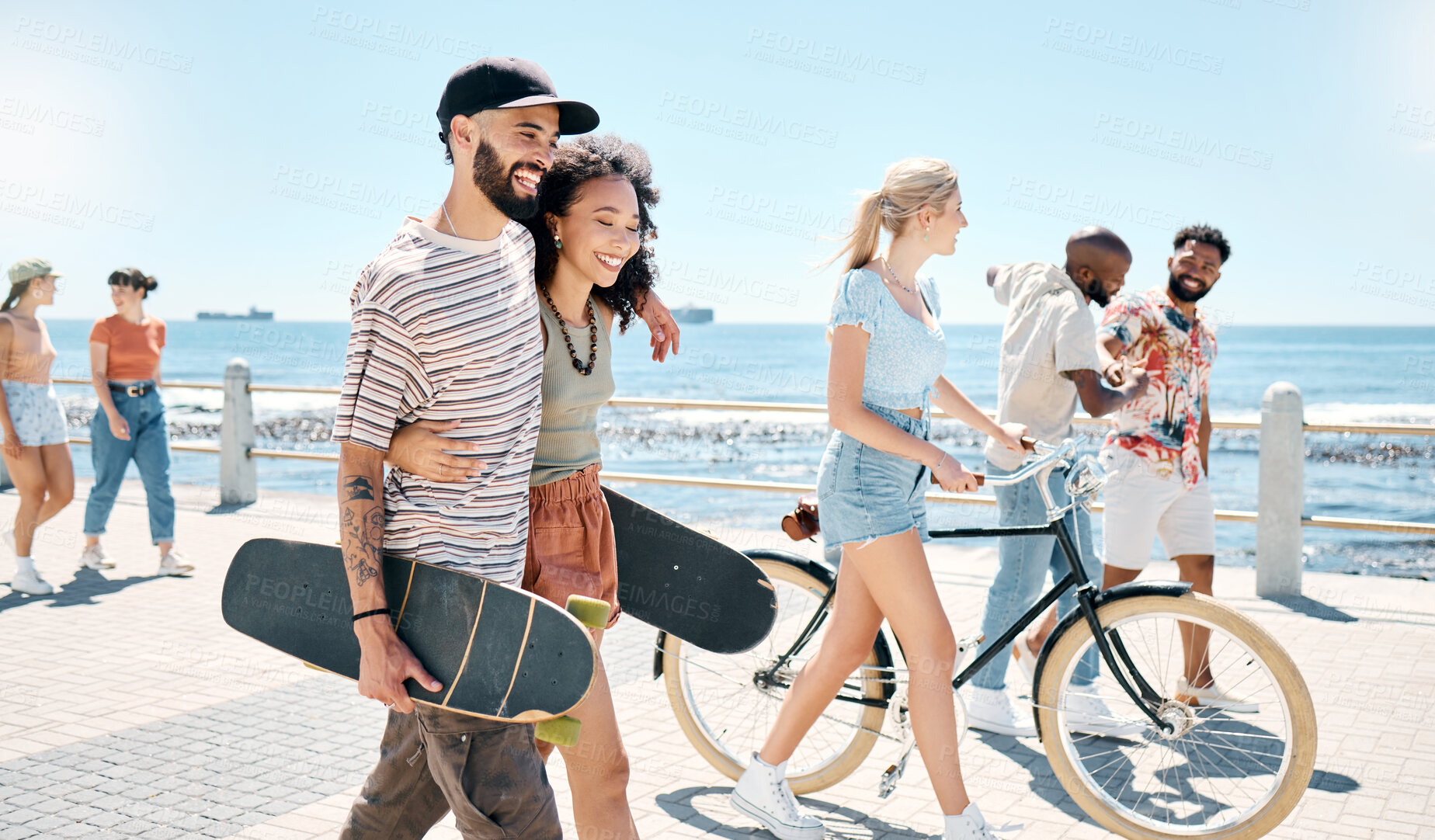 Buy stock photo Shot of a young couple waking together during a day outdoors with their friends