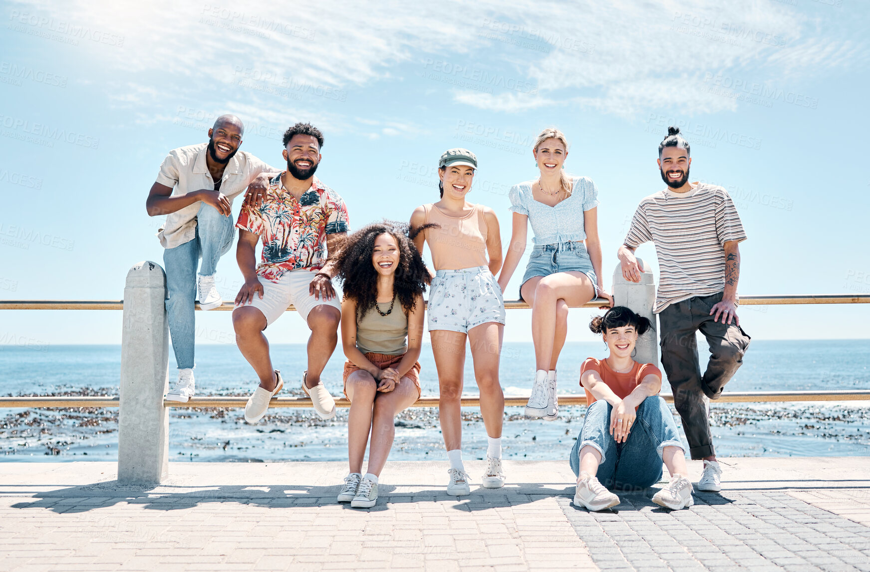 Buy stock photo Full length shot of a diverse group of friends bonding together during a day outdoors