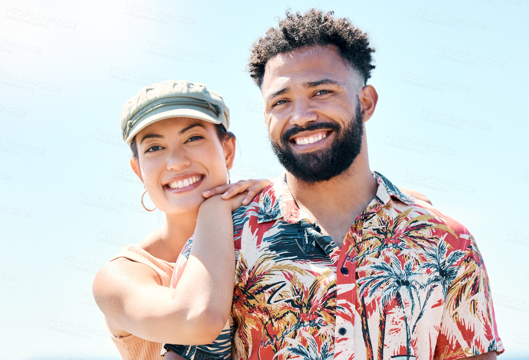 Buy stock photo Shot of a young couple standing together and bonding during a day outdoors